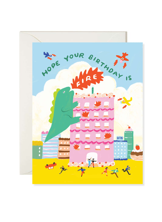 Illustrated birthday greeting card featuring a green monster climbing a pink cake surrounded by flames with “Hope Your Birthday Is Fire” text by Karen Schipper.
