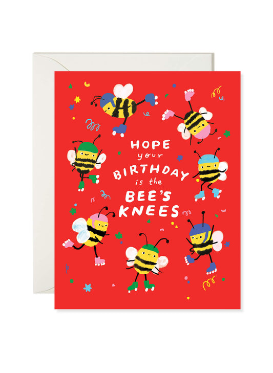Illustrated birthday greeting card featuring bees dancing on a red background with “Hope Your Birthday Is the Bee’s Knees” text by Karen Schipper.
