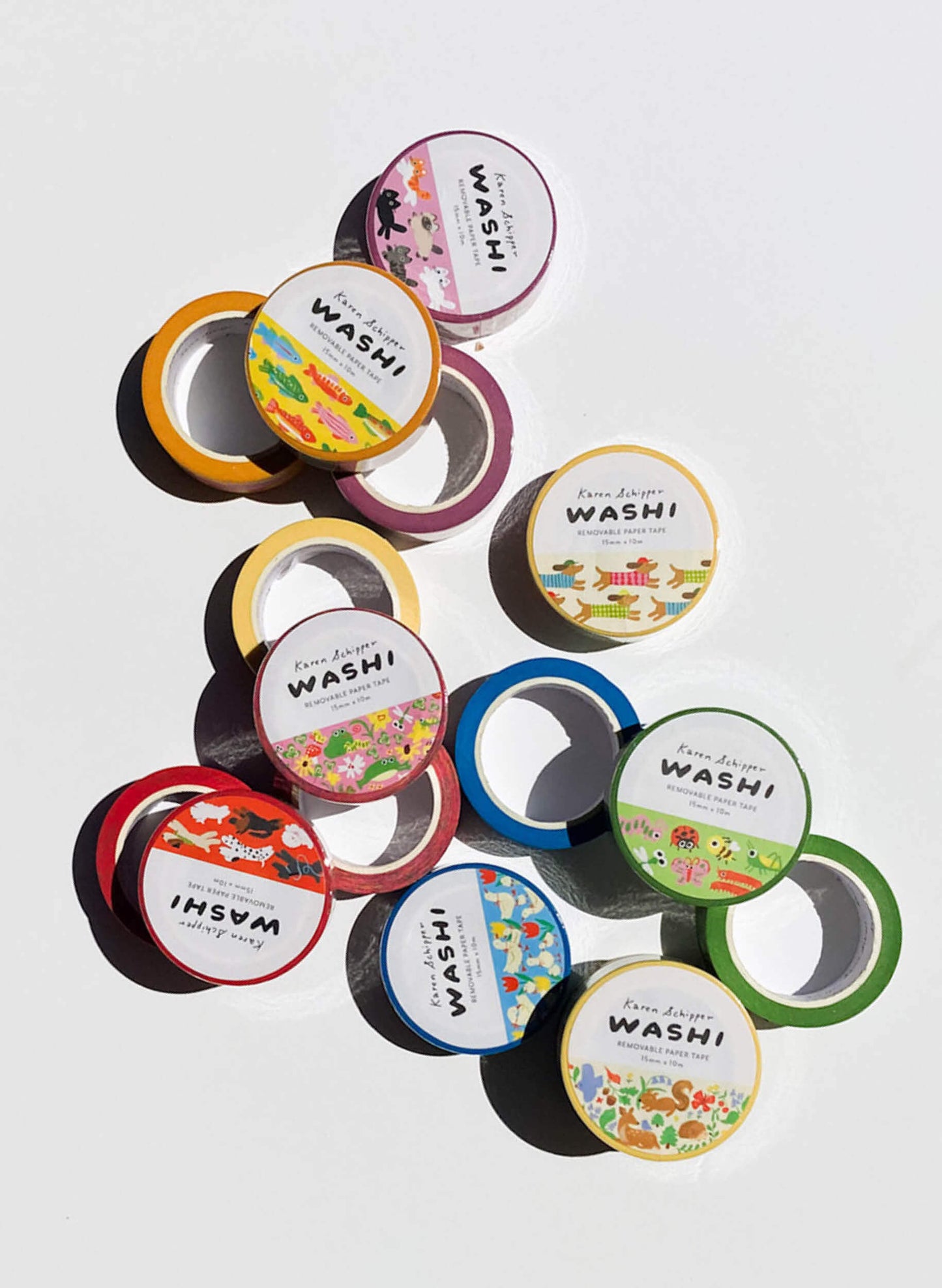 Collection of washi tape rolls with colorful labels on a white background