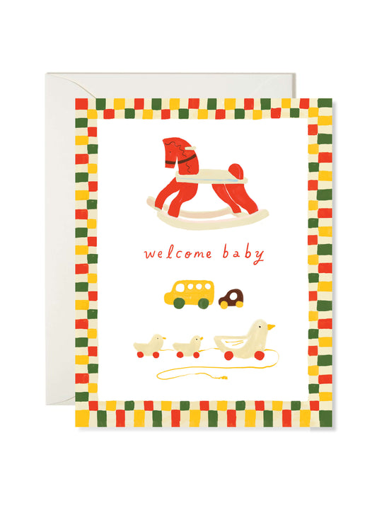 Wooden Toy Baby Card by Karen Schipper featuring a rocking horse, toy cars, and a pull-along duck with a welcome baby message and colorful border.