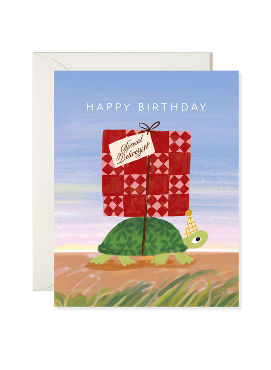 Turtle Delivery Birthday Card by Karen Schipper featuring a turtle in a party hat carrying a red special delivery birthday gift.
