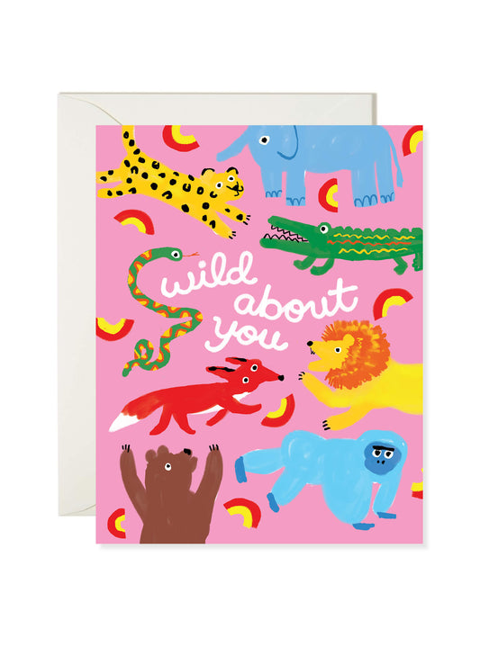Wild About You Greeting Card by Karen Schipper featuring colorful jungle animals and playful love lettering on a pink background.