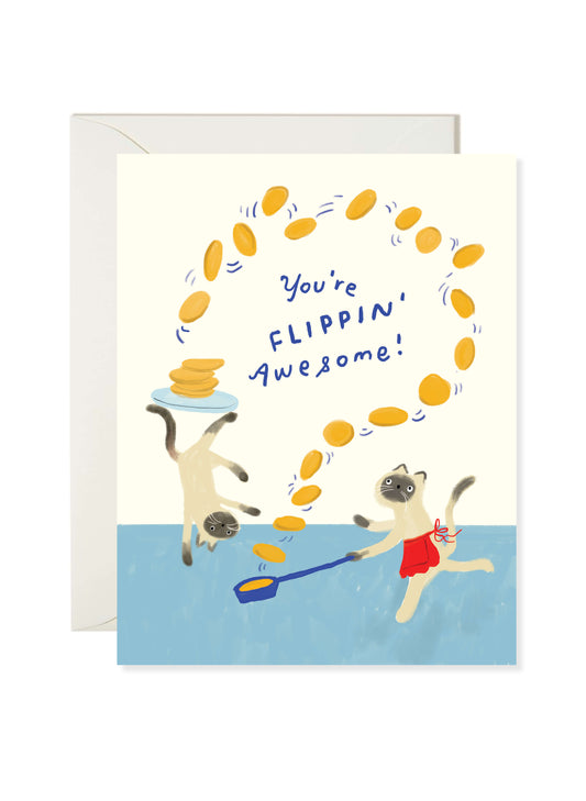 Flipping Awesome Card by Karen Schipper featuring two cats flipping yellow pancakes with a spatula and the message “You’re flippin’ awesome!” on a cream and blue background.