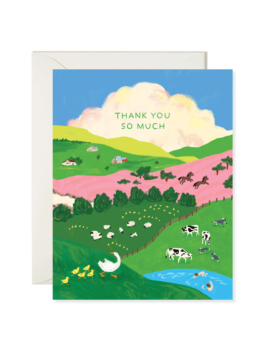 Farmland Thank You Card by Karen Schipper featuring a scenic landscape with green hills, pink fields, cows and sheep, a pond, and the text “Thank you so much”.