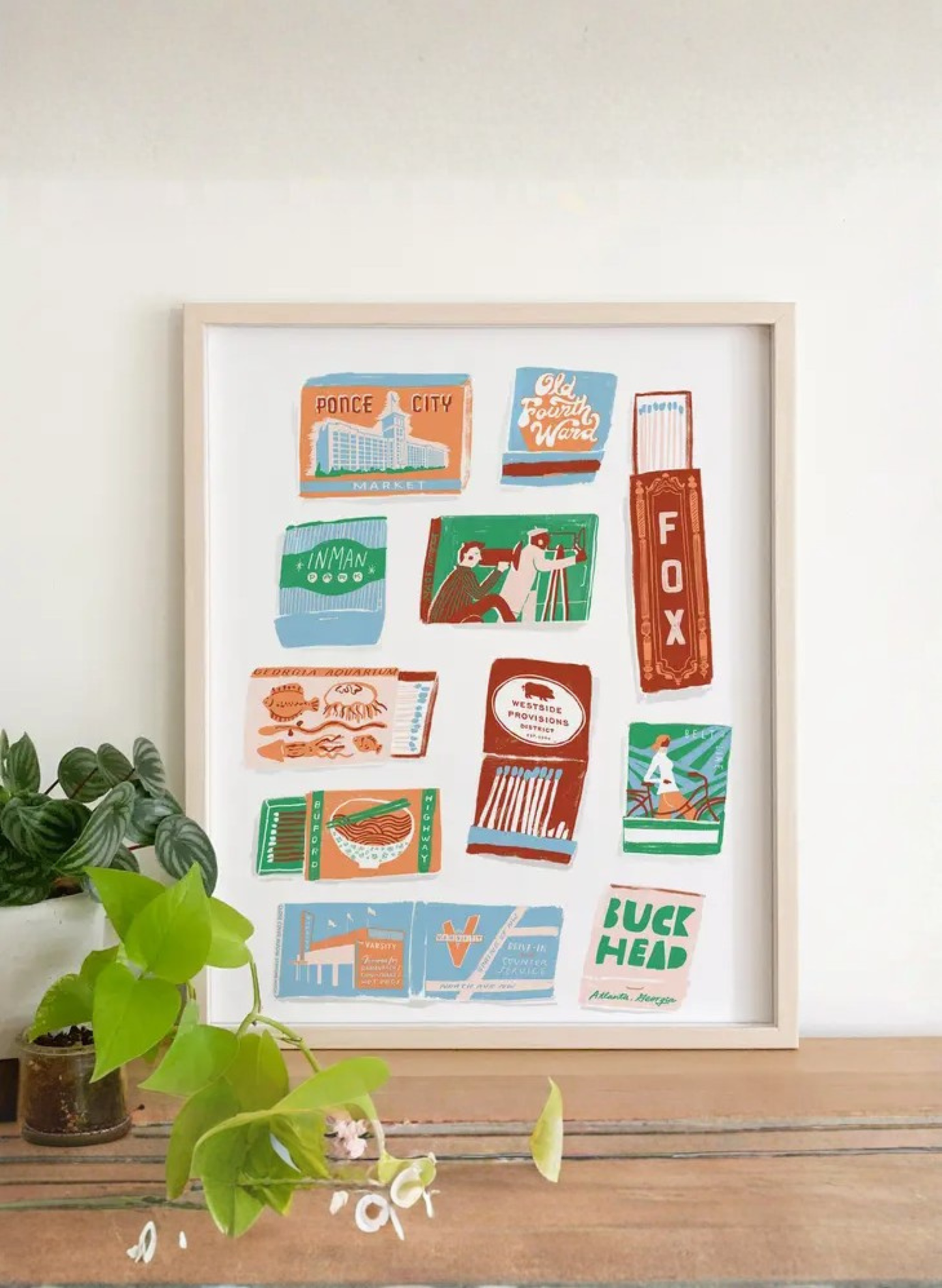 Framed Atlanta Matchbook Art Print by Karen Schipper styled as colorful Georgia city wall art with vintage-inspired local landmark illustrations.