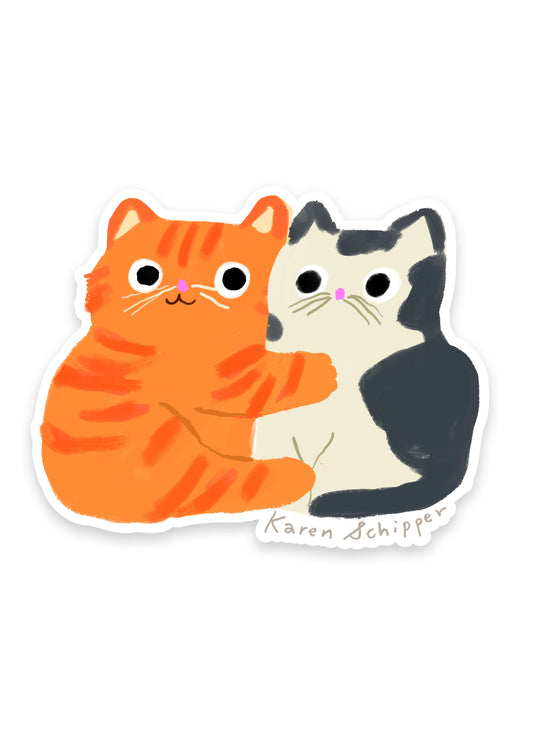 Cat Hug Sticker by Karen Schipper featuring an orange tabby hugging a black-and-white cat in a simple, cute illustrated style.