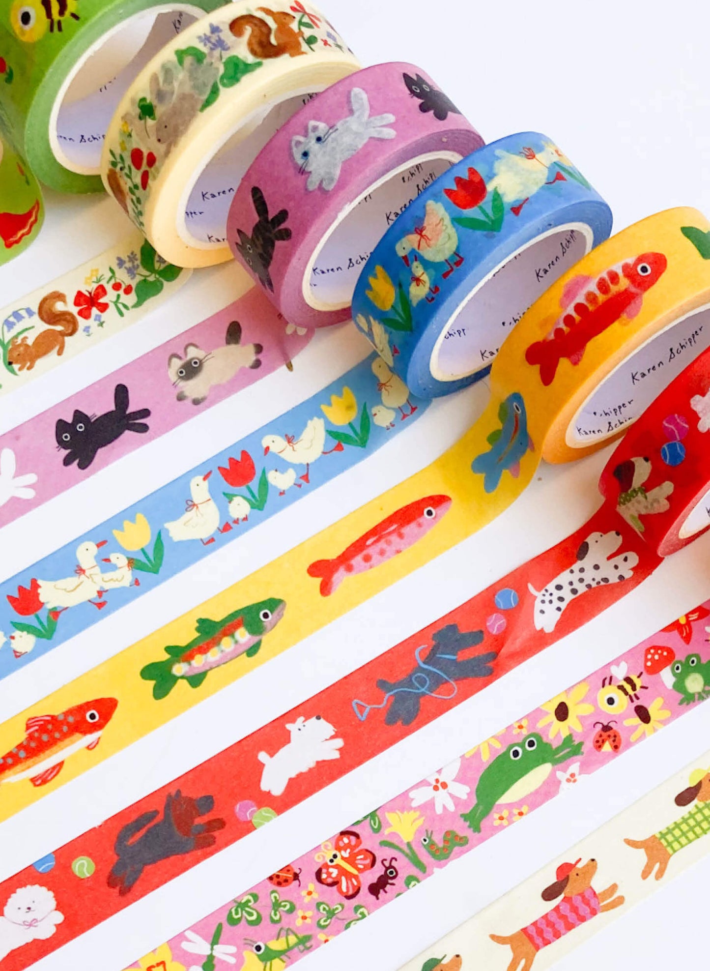 Set of colorful washi tape rolls with animal and nature designs on a white background
